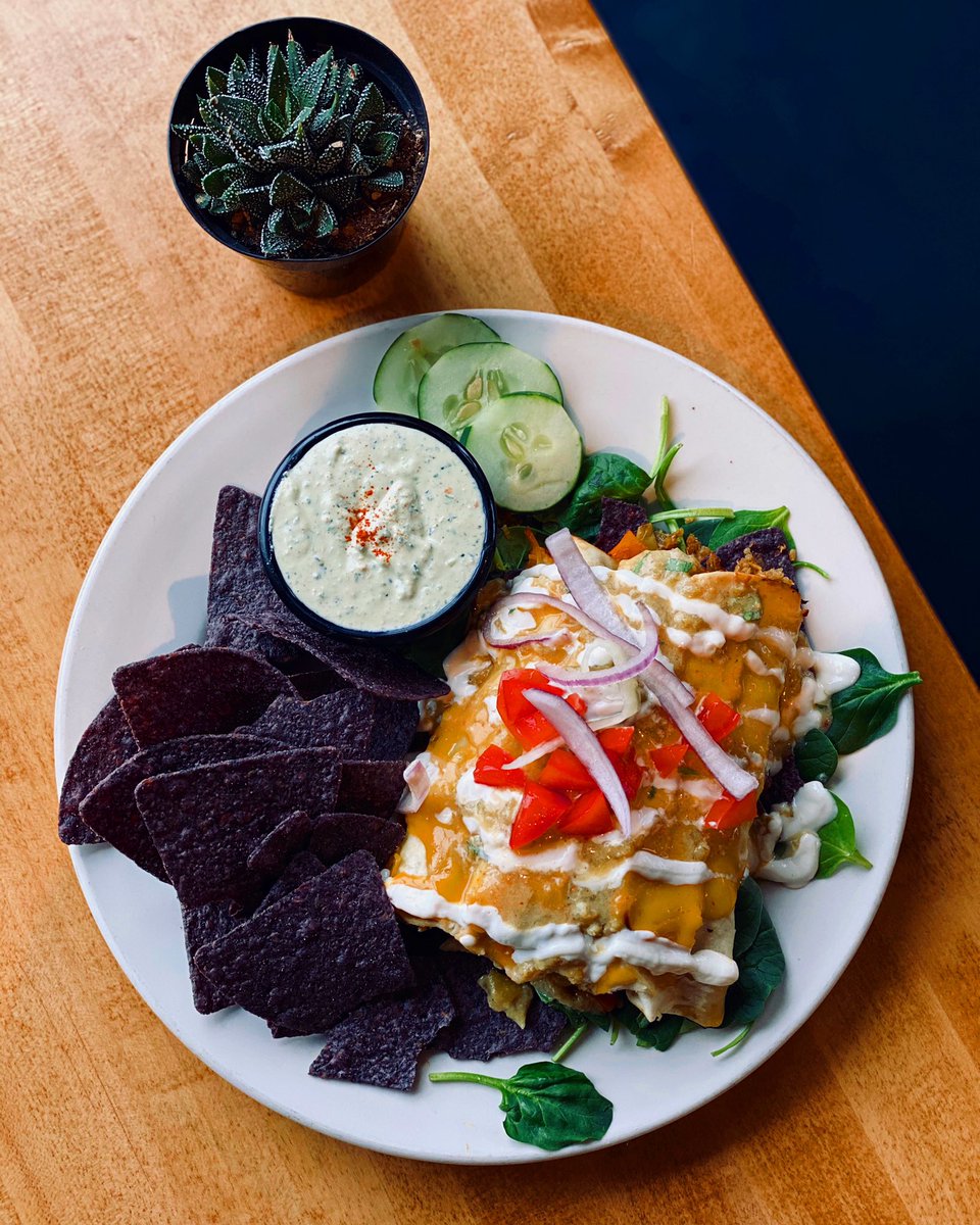 🌱Thursday’s Special🌱
“Smokey Artichoke 3 Cheese Enchiladas”
- 3 Enchiladas served over a bed of spinach and corn chips, filled with smokey veggies &amp; quinoa. Topped w/ vegan cheddar, swiss and queso, enchilada sauce, tomatoes, onions and sour cream! Comes with a side!