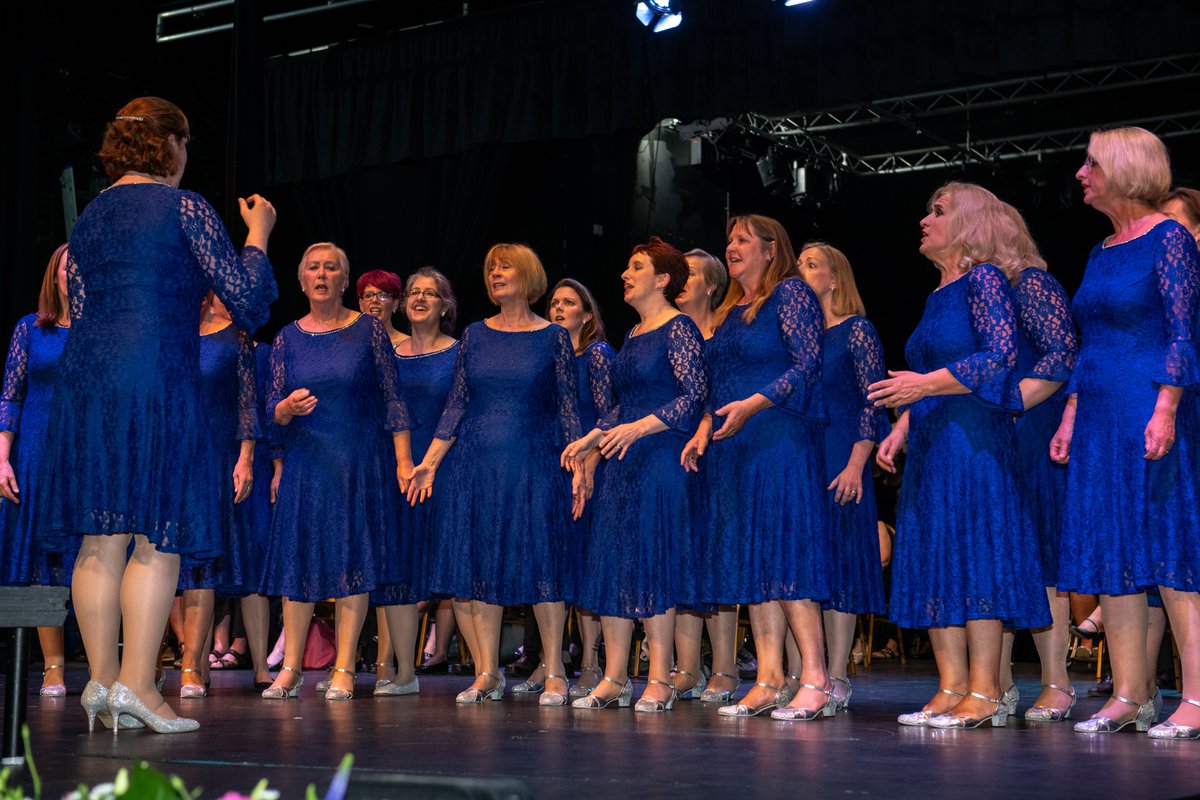 group of female singers performing on stage