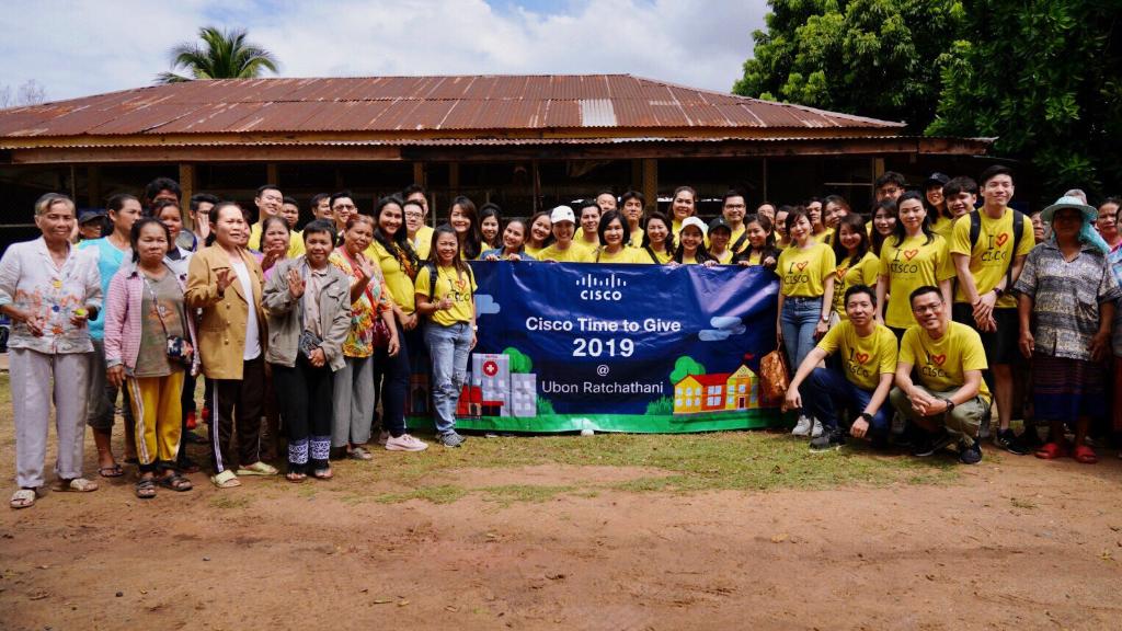 A group of employees holding a sign that says "Cisco Time To Give 2019 at Ubon Ratchathani"
