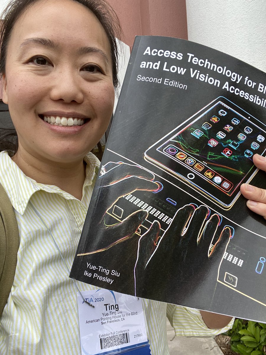 Ting holds up a copy of the book with a big smile