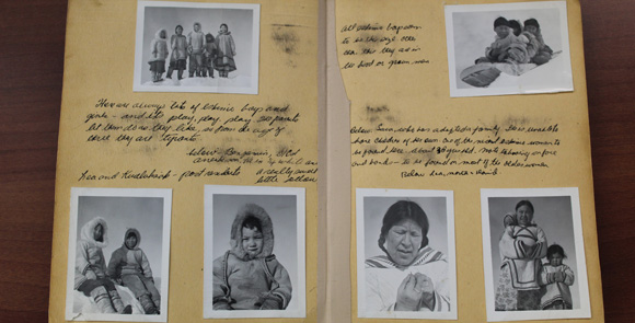 Old photos and handwritten descriptions displayed in an album.