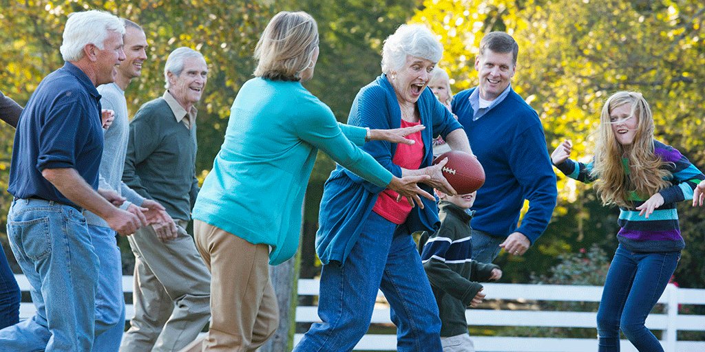 A multigenerational family playing football