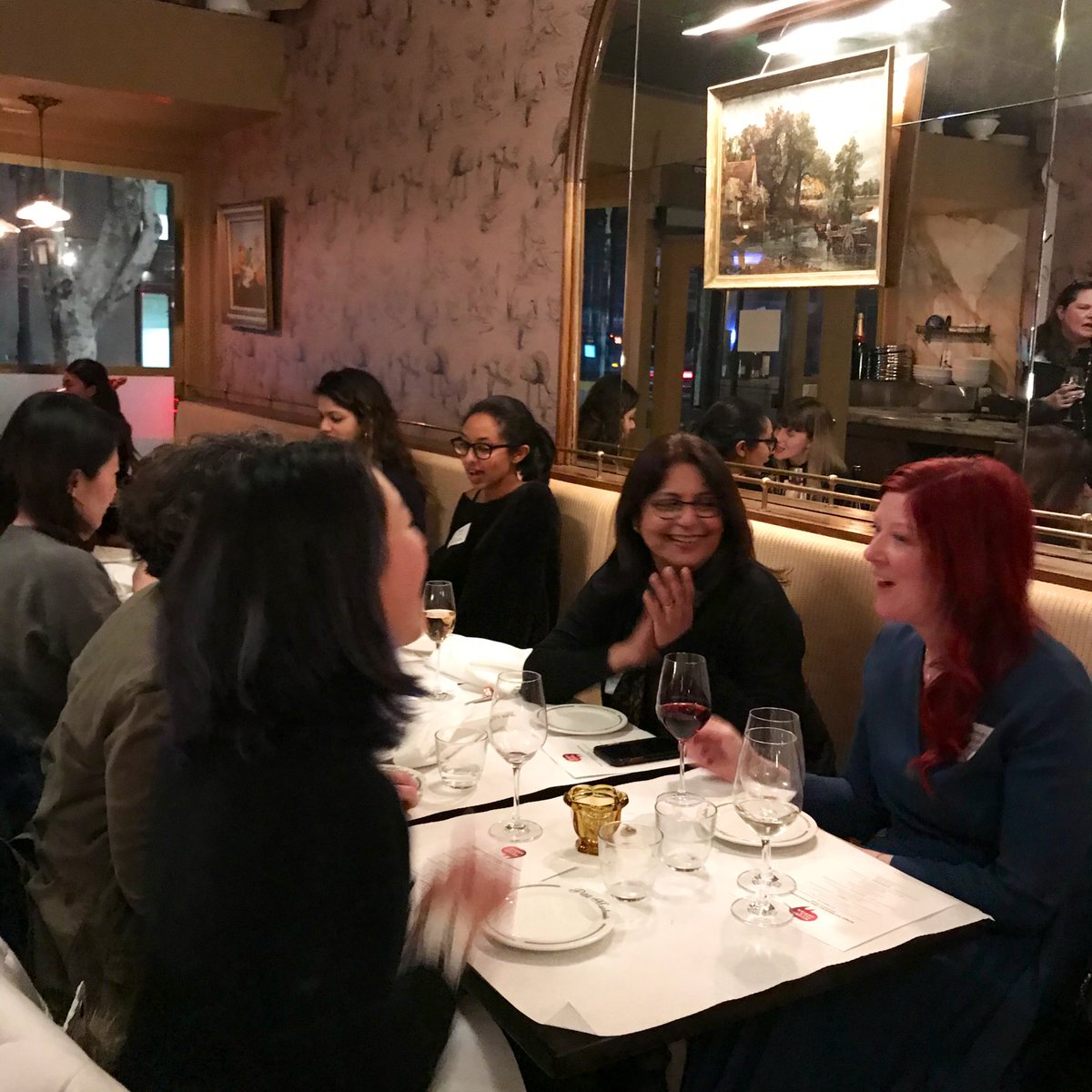 Close up of 4 speakers talking at a table during Women Talk design speakers dinner
