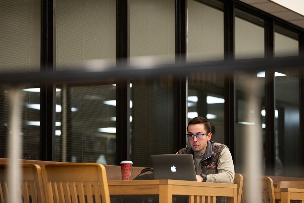 A student studying in the Dean B. Ellis library.