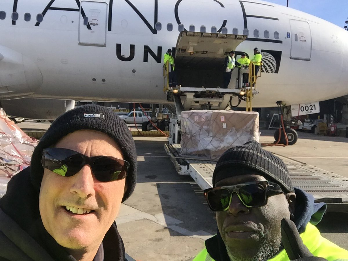 Two veteran Ramp Servicemen watching a wide body training class loading a flt on a brisk sunny morning in EWR ⁦⁦@weareunited⁩