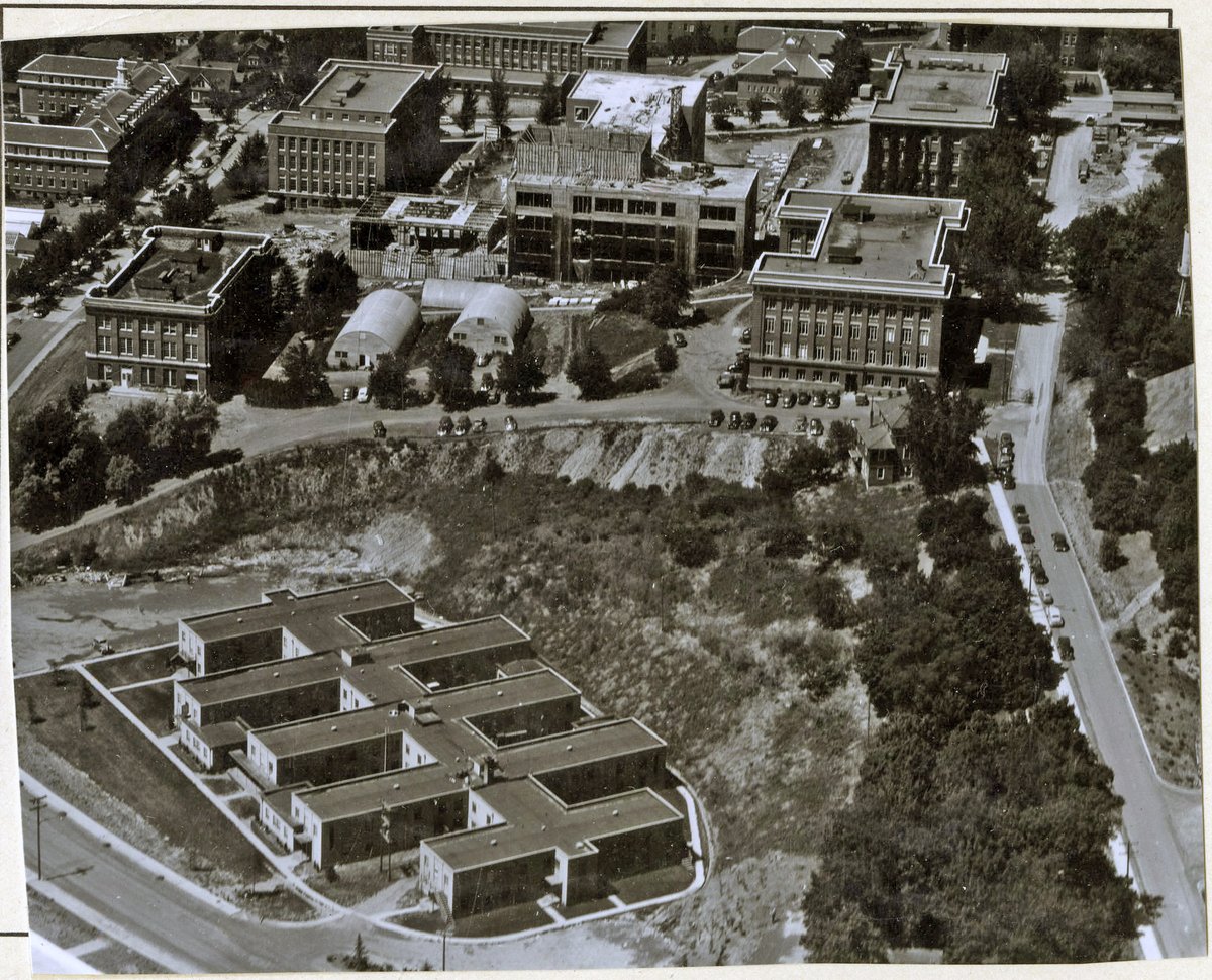 A black and white 1948 aerial view of the WSU Pullman campus. West House is in the foreground, and Todd Hall is under construction in the center, surrounded by Fulmer, College, Wilson, and Troy Halls
