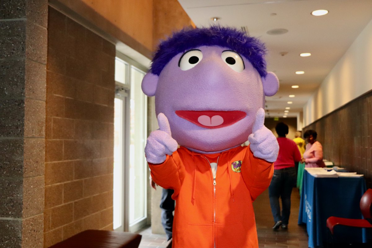 A person dressed as Ed, from Mississippi Public Broadcasting, shows thumbs up at the health fair.