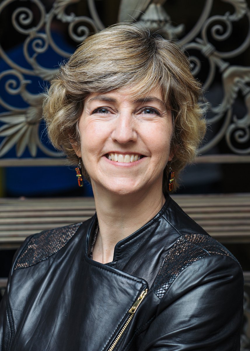 Jody Todd Manly of the University of Rochester's Mt. Hope Family Center smiles for the camera in a stylish do and Moto jacket.