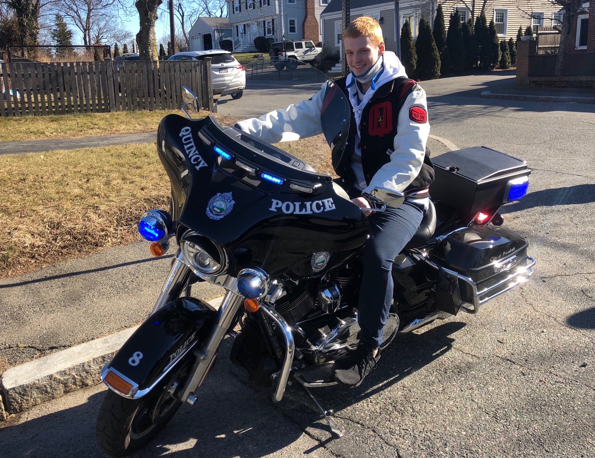 connor sititng on quincy police motorcycle