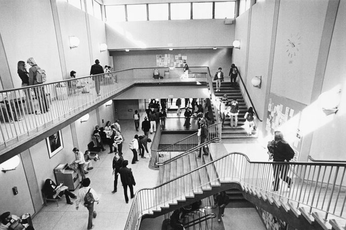 Black and white image of Olson Hall in 1963 filled with students
