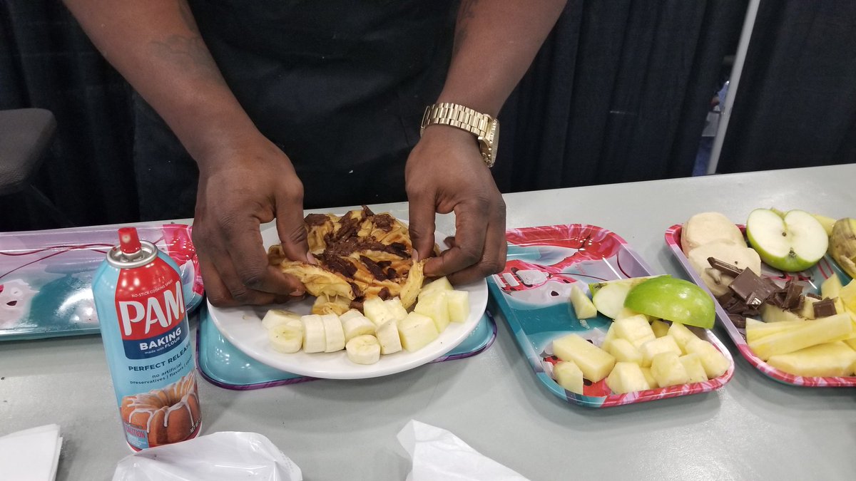 The chef making a chocolate chip waffle with banana slices on the side.