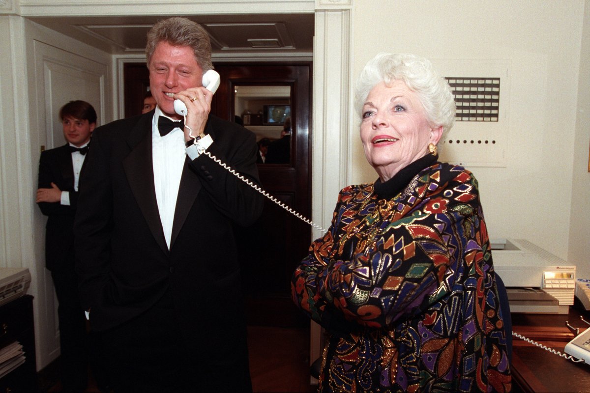Another angle of President Clinton speaking on the phone with Governor Ann Richards nearby. 