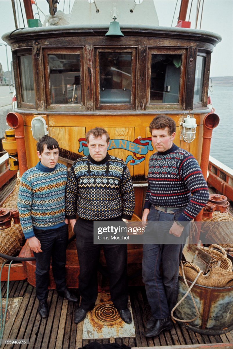 Three Fishermen on the deck of their boat 'Planet' in the harbour of the Shetland Isle of Whalsay.