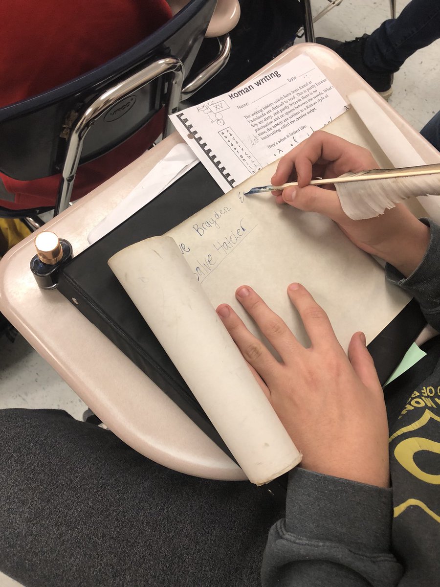 Latin 1 students practicing Roman cursive, writing on tablets and scrolls(papyrus).