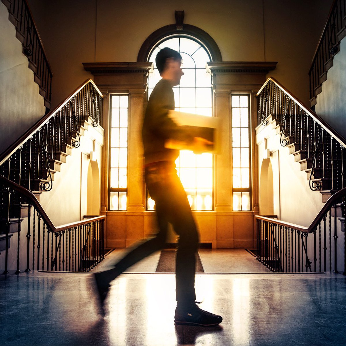 A student walks past a window at the Plant Science building at Cornell University