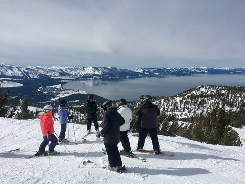Ranger speaks to Ski with a Ranger Participants with panoramic view of Lake Tahoe in background.