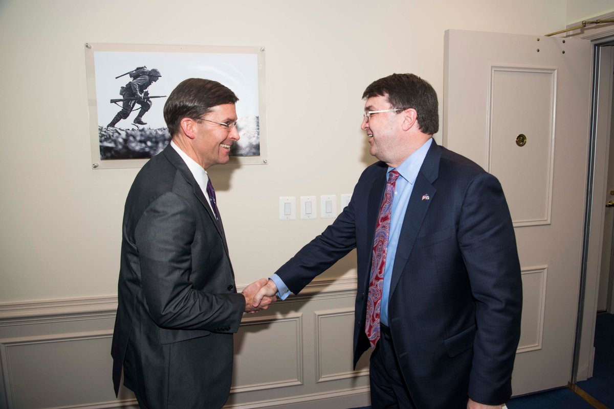Secretary Esper shakes hands with Secretary Wilkie.