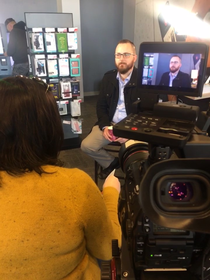 Woman interviewing man on camera