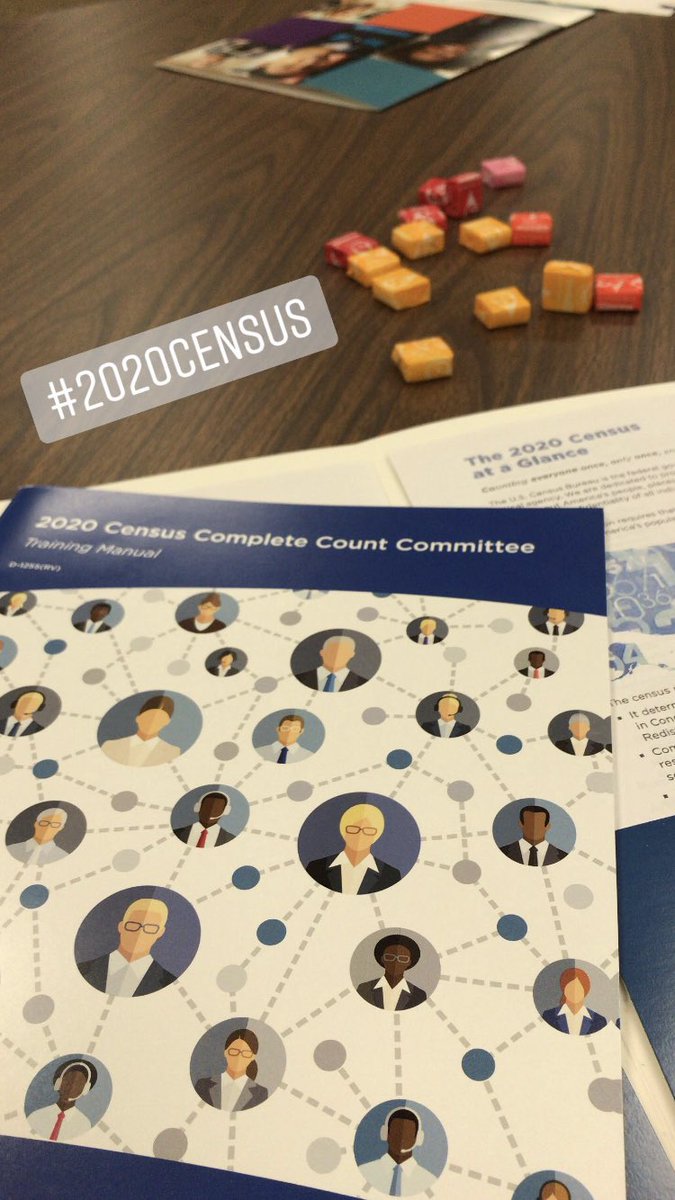 Census complete count committee training materials and starburst candies on top of a table. Text on image says “#2020Census”