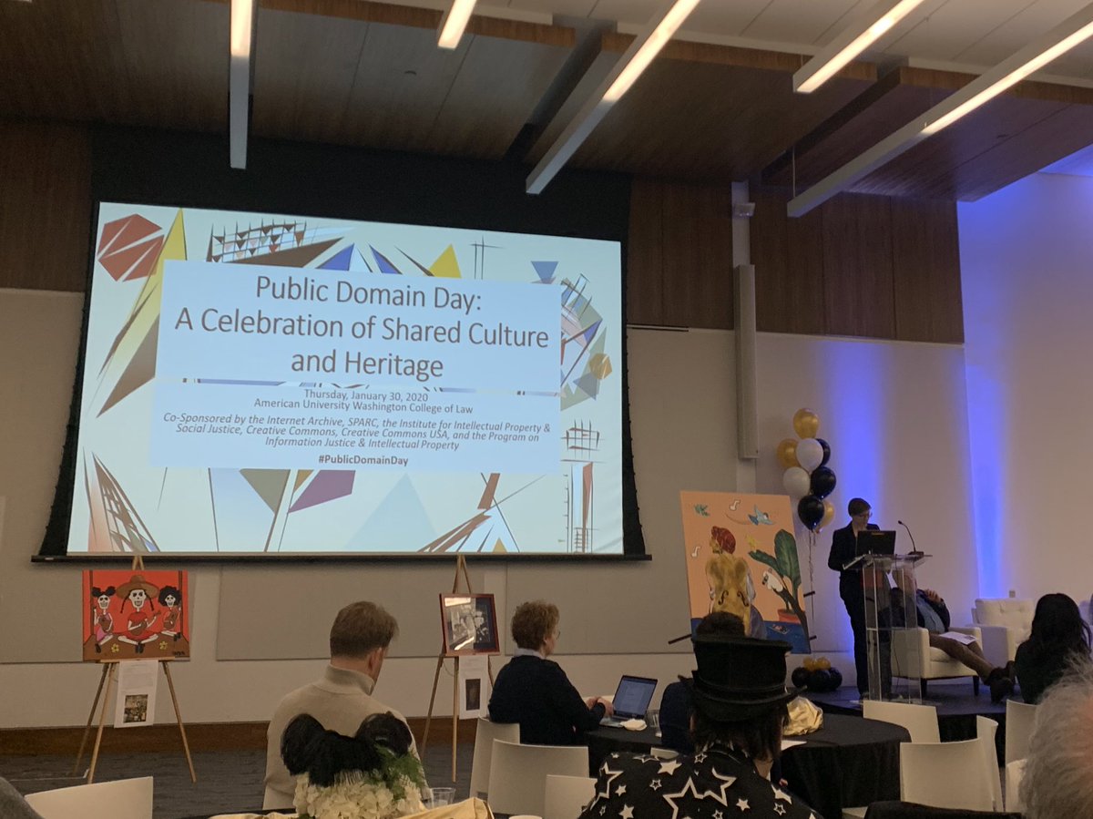 Julia Reda speaking on a podium with a slide in the background that says Public Domain Day