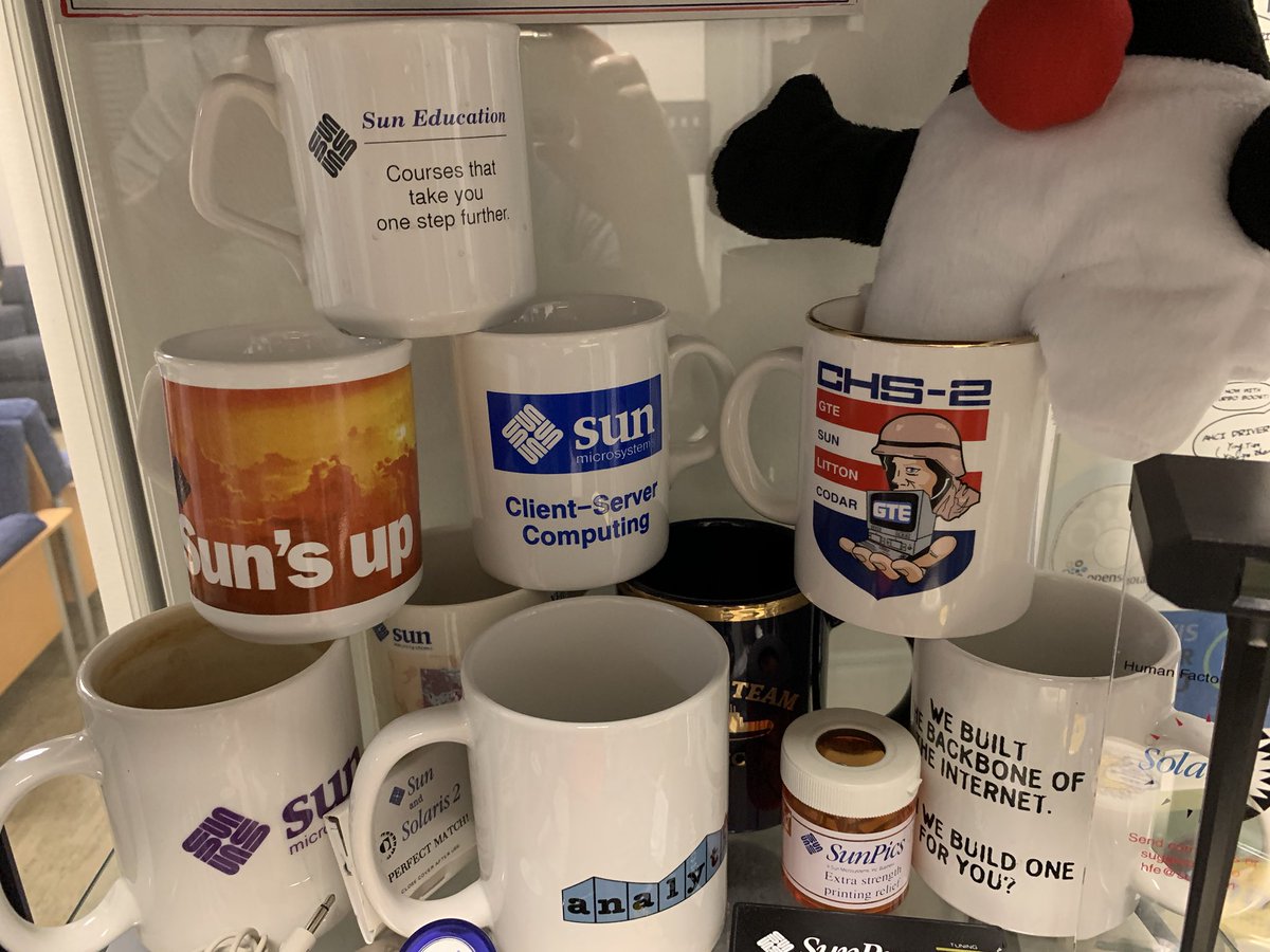 Stack of various Sun Microsystems coffee mugs
