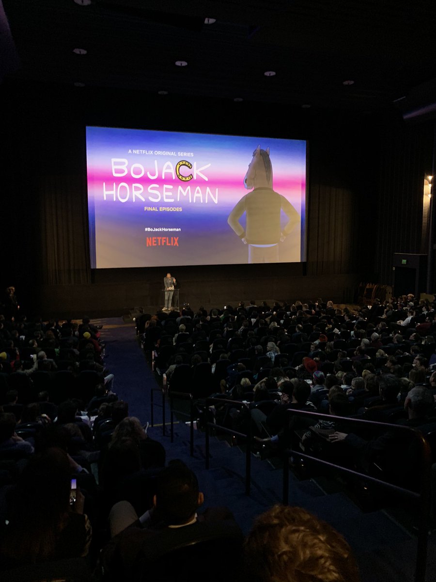 full theatre with Raphael speaking and “bojack horseman” splash screen behind him