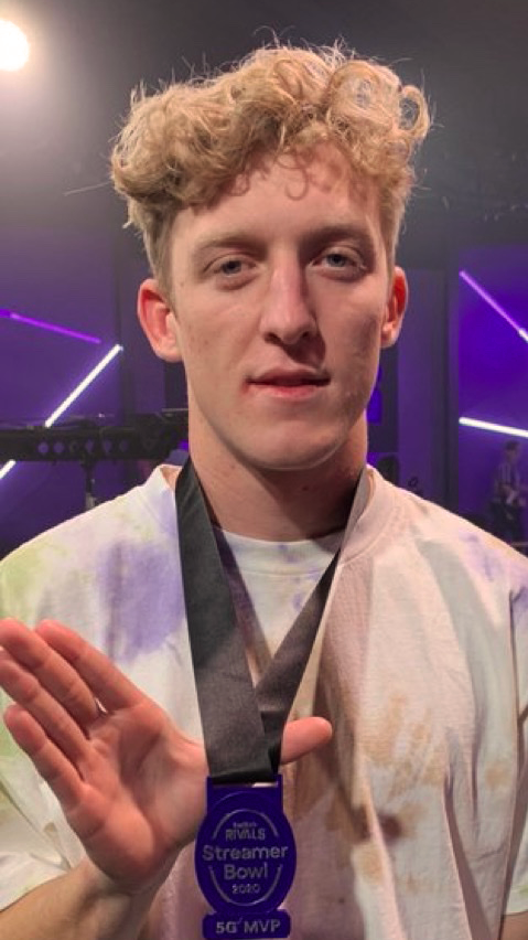 Tfue smiling while wearing Verizon 5G MVP medal.