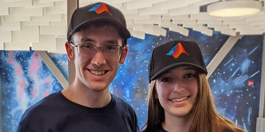 boy and girl wearing MATLAB shirts and hats
