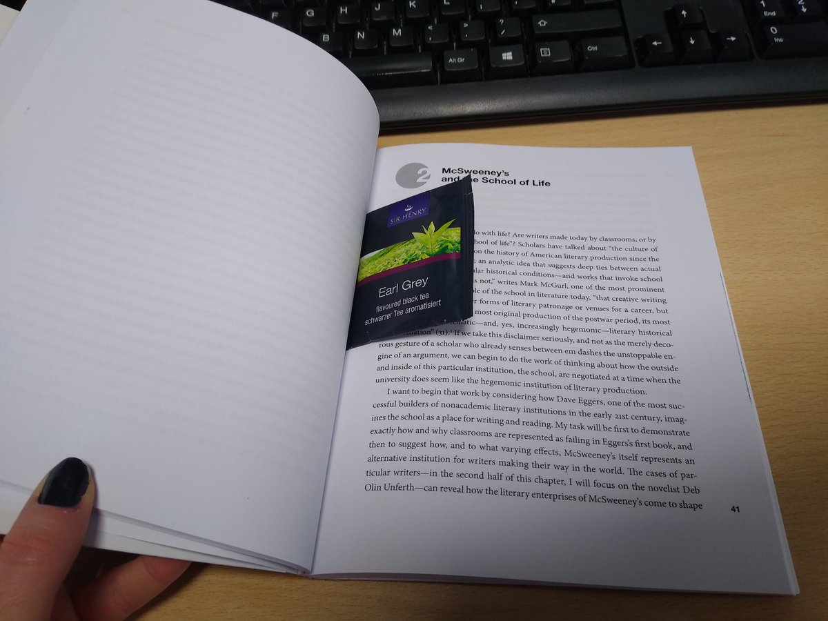 A photo of a single-pack of Earl Grey tea tucked inside a book.