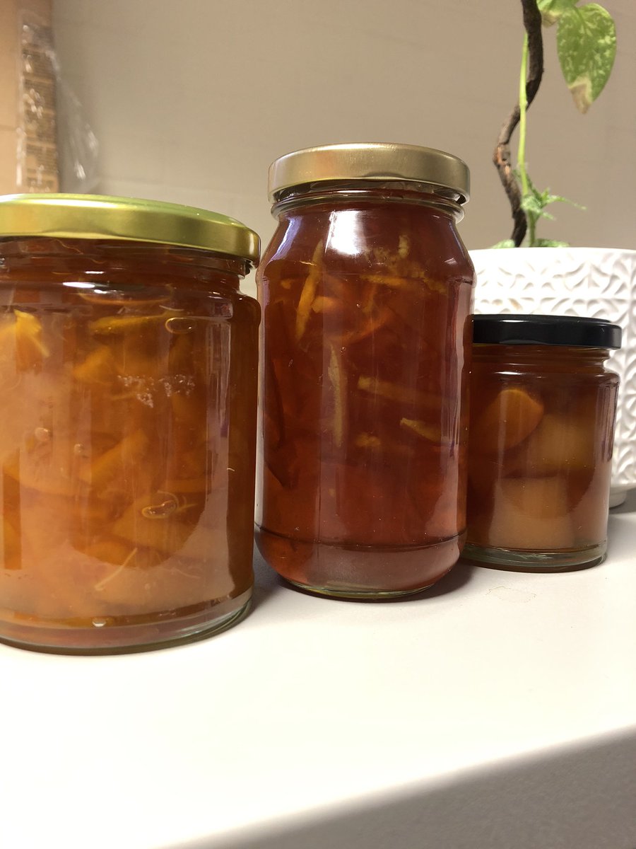 3 jars of marmalade lined up in a row.