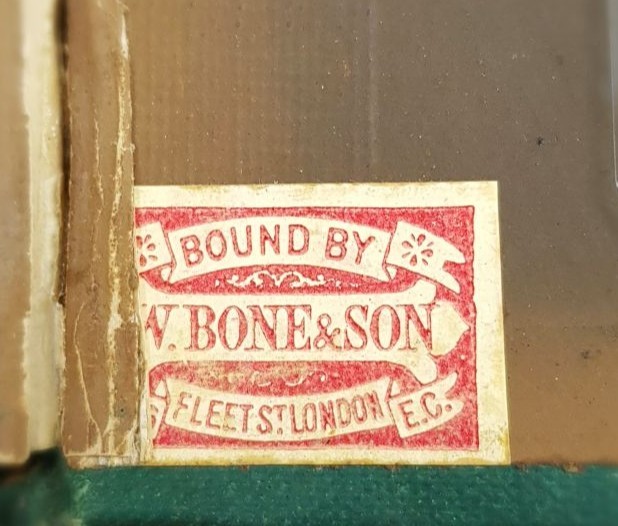 A rectangular red and cream label inside a book which says 'Bound by W. Bone & Son, Fleet Street London E.C.