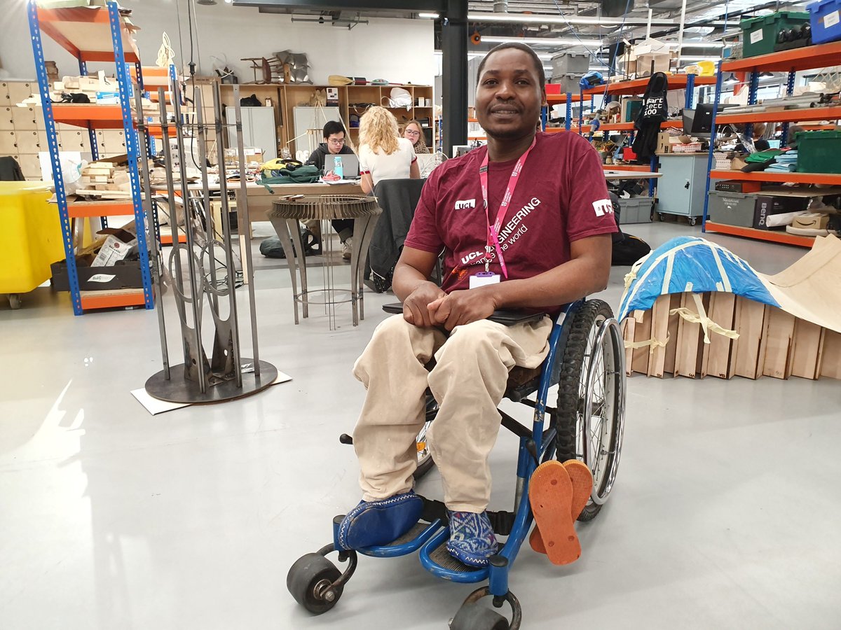 A student who uses a wheelchair is sitting in one of UCL Here East workshops.