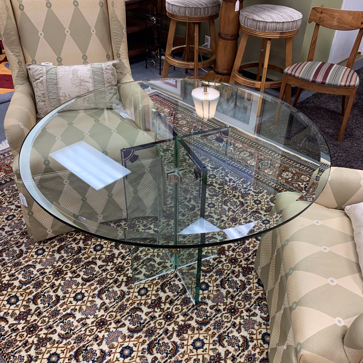 This round glass dining table has adorable small purple emblems on the base.  Barely noticable but they add a dimension. The table is 42” in diameter and 30” tall. #rounddiningtable #glassdiningtable #raleighconsignments #highendfurniture #sohoconsignments @sohoconsignments