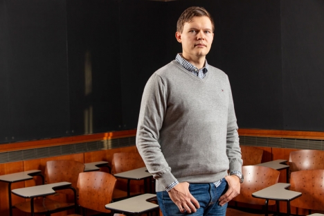 Semyon Dyatlov is standing in a classroom with his thumbs hooked in his pockets.