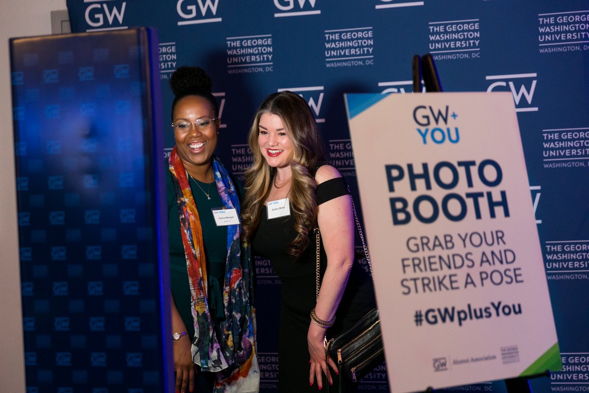 two women posing and smiling in photo booth