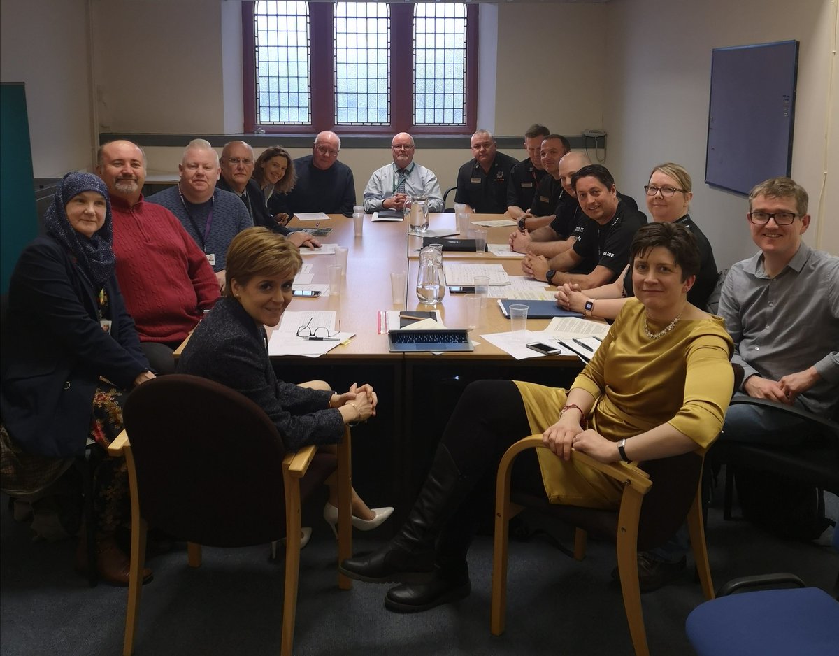 Nicola, Alison, and stakeholders round a large table