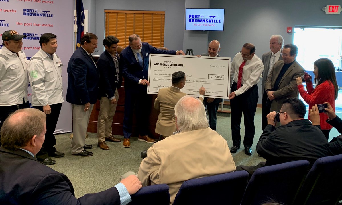 Elected officials, community stakeholders join Texas Workforce Commissioner Julian Alvarez as he signs the ceremonial check.