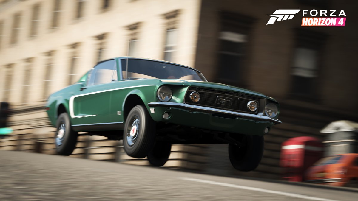A green 1968 Ford Mustang GT speeds down a busy road. Text Reads: Forza Horizon 4.