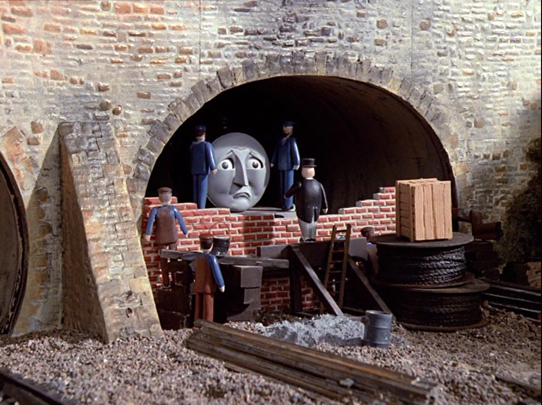 Gordon from Thomas The Tank Engine being bricked up in a tunnel