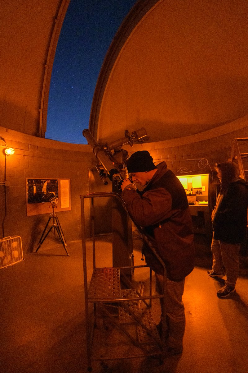 Students gaze through a telescope at Mount Cuba Observatory 