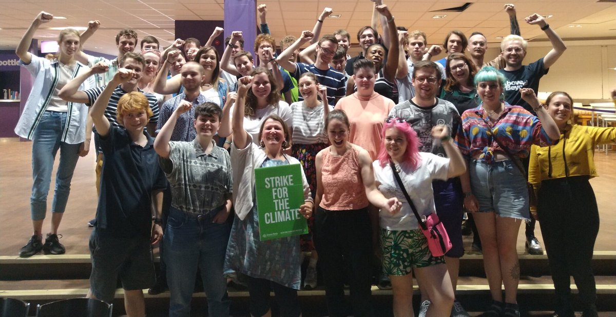 Ellie Chowns and a big group of Young Greens raise their fists at last year's convention