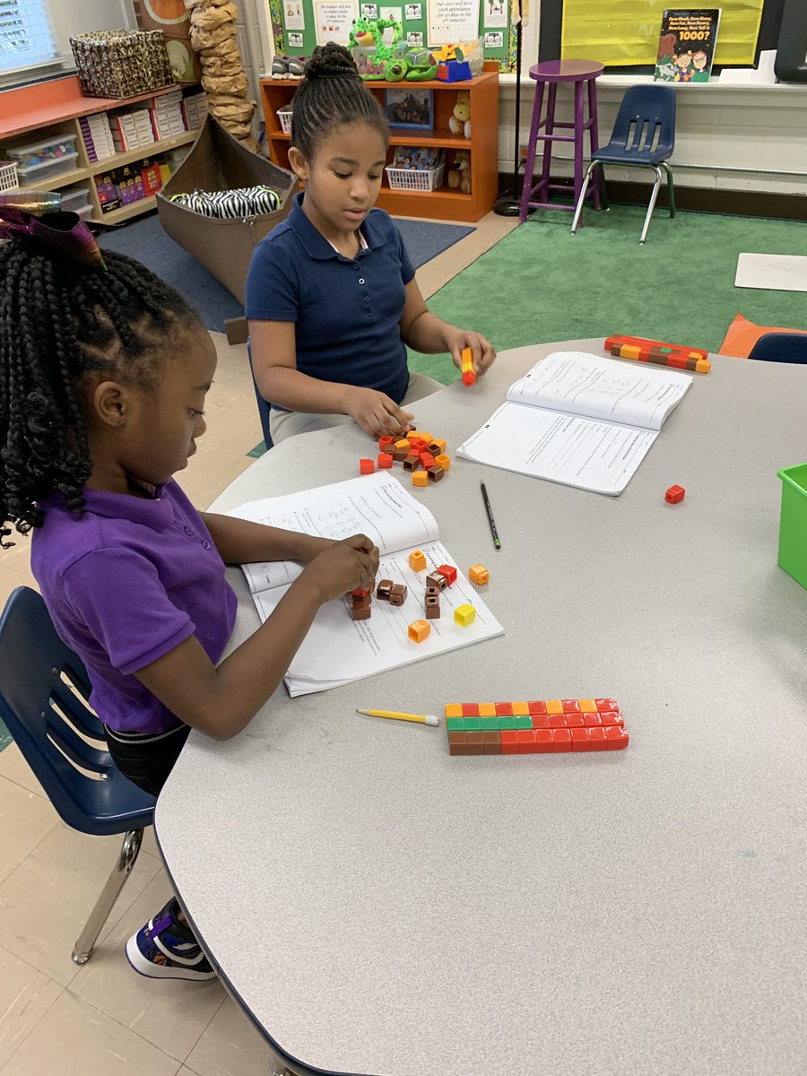 MrsElizabeth08's tweet photo. This week we worked on building place value understanding to 1,000. Our lessons incorporated craft sticks, base ten area pieces, and Unifix cubes. #LifeIn2ndGrade #HESPouncers @MLCmath https://t.co/GuLWSSS5n5