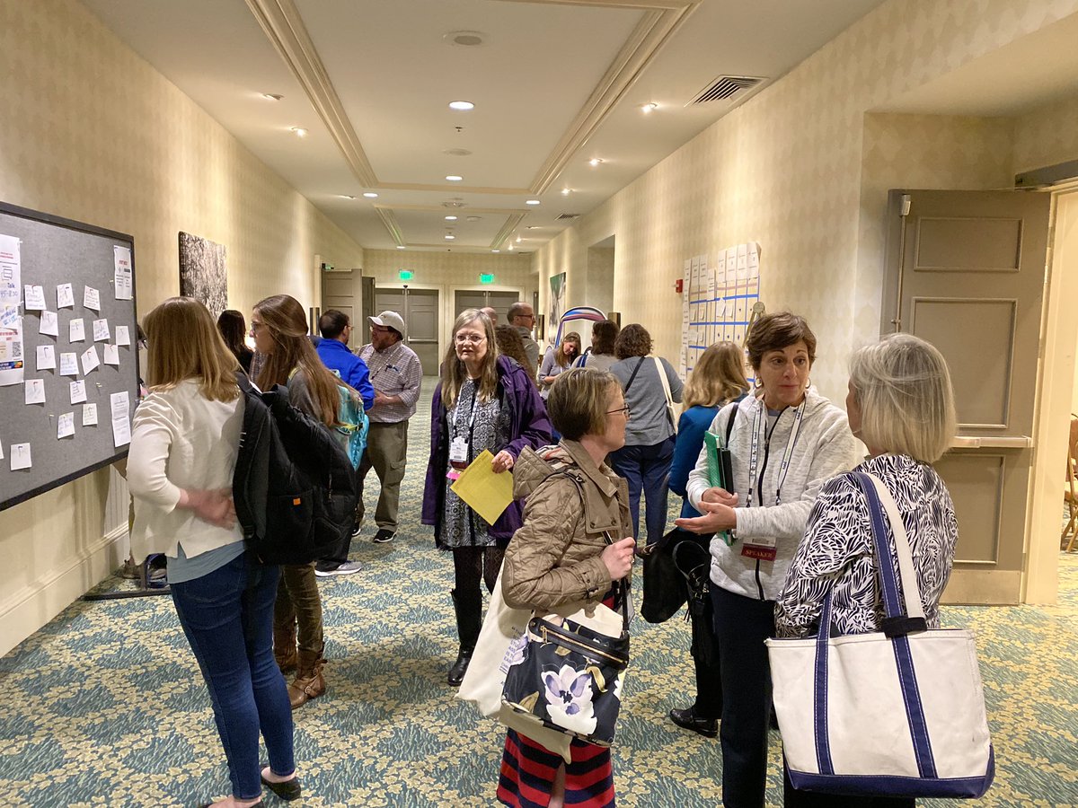 People standing in hallway talking