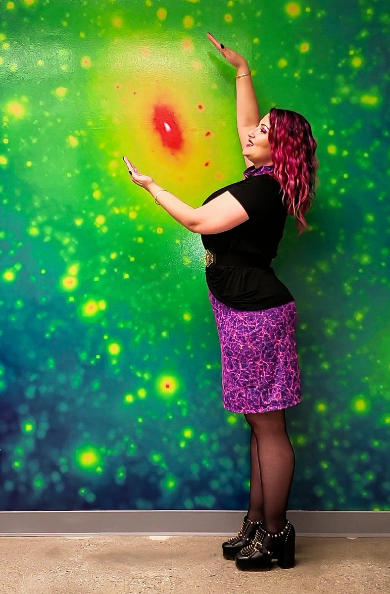 Me in a dark matter cosmic web dress in front of a simulated dark matter halo background