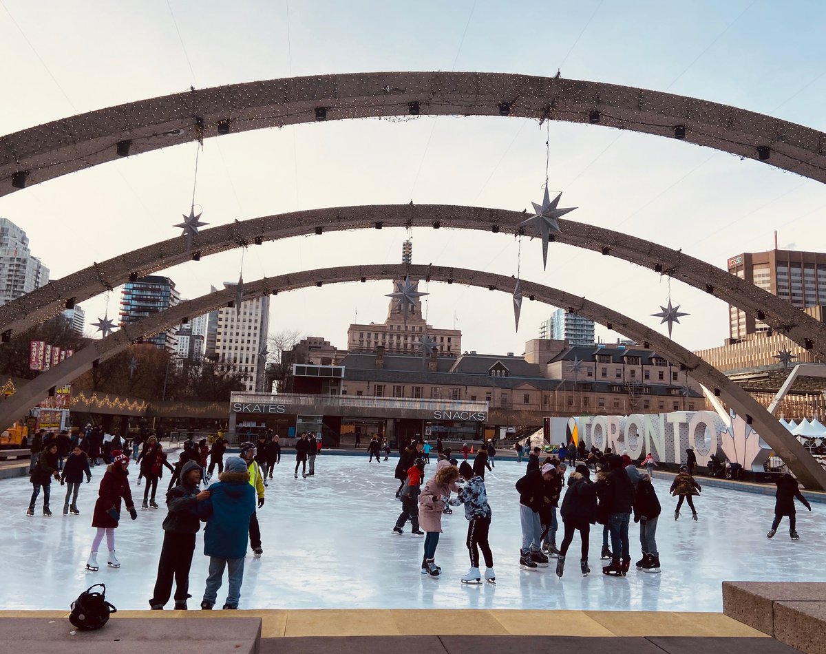 Photo of people skating during the day on the Nathan Phillips Square rink