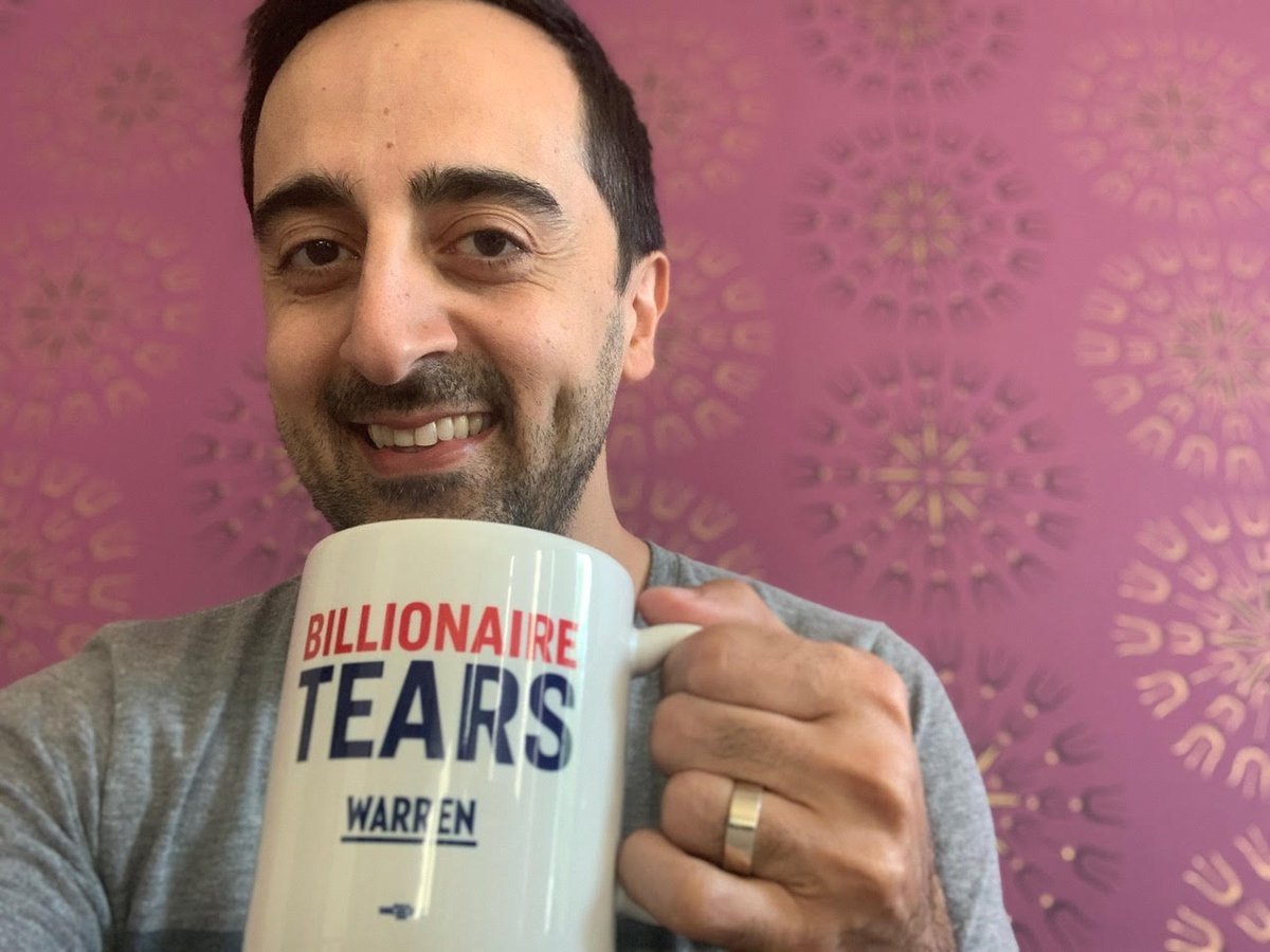 Call Crew volunteer Amir Talai holds his Billionaire Tears mug