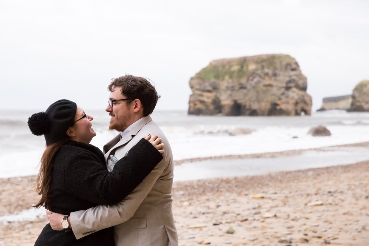 Couple on beach by Marsden Rock