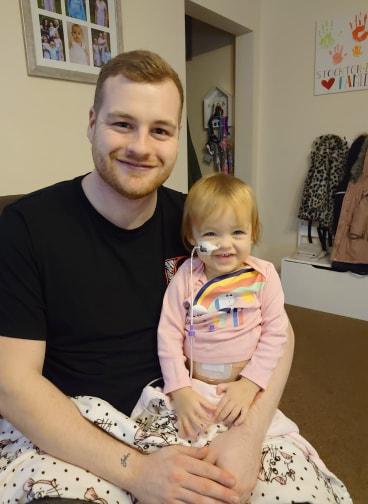 Dean and Isabella smiling at home.