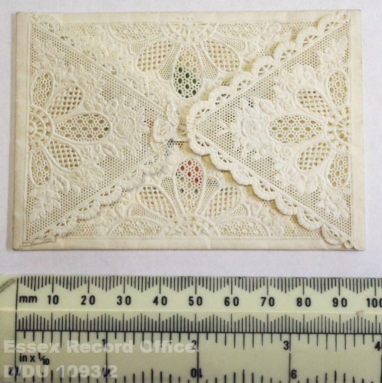 Four triangles of lace overlapping in an envelope style. Measured against ruler as approx. 100mm