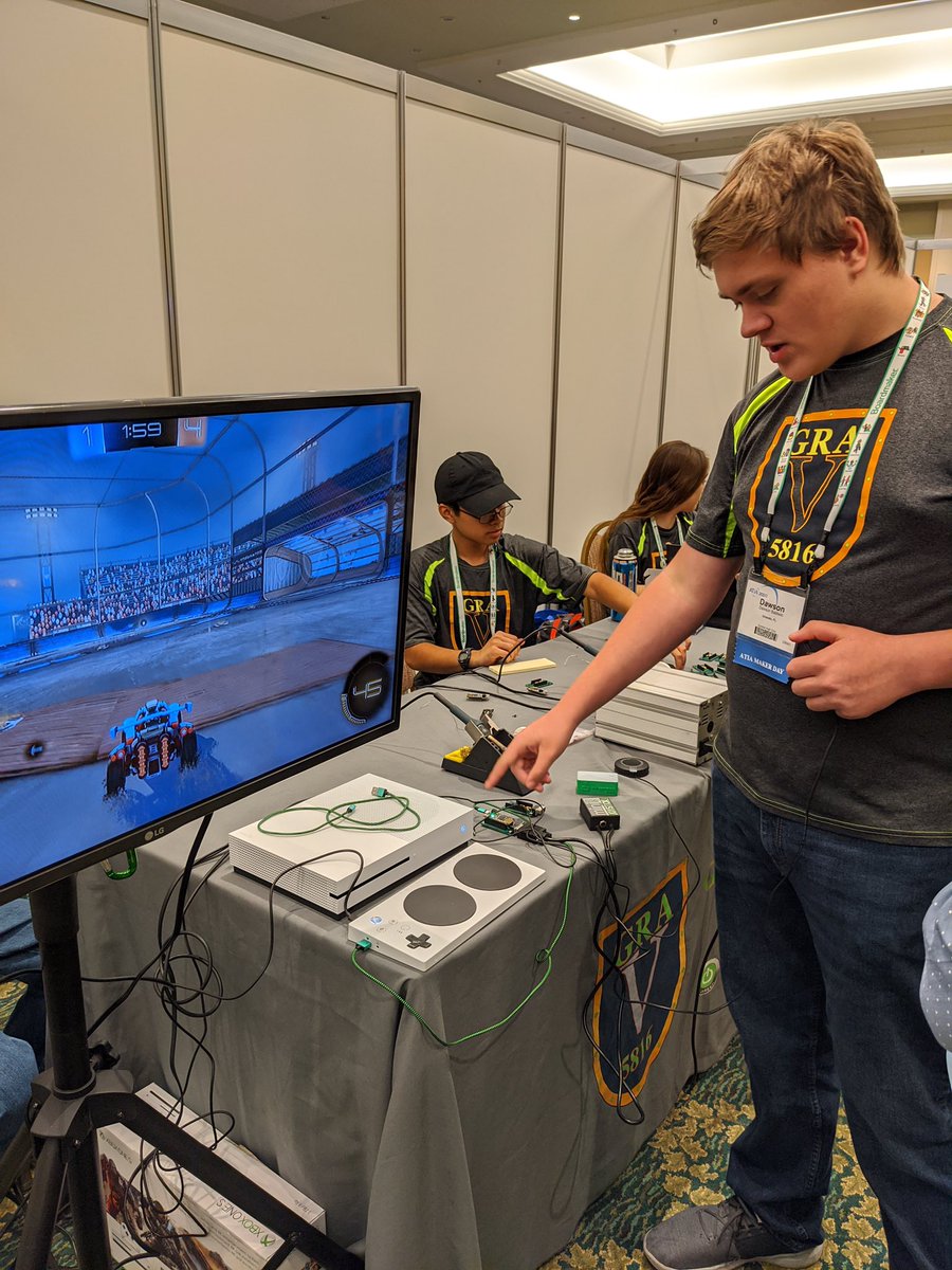 Person standing infront of an Xbox and tv demonstrating the adapter